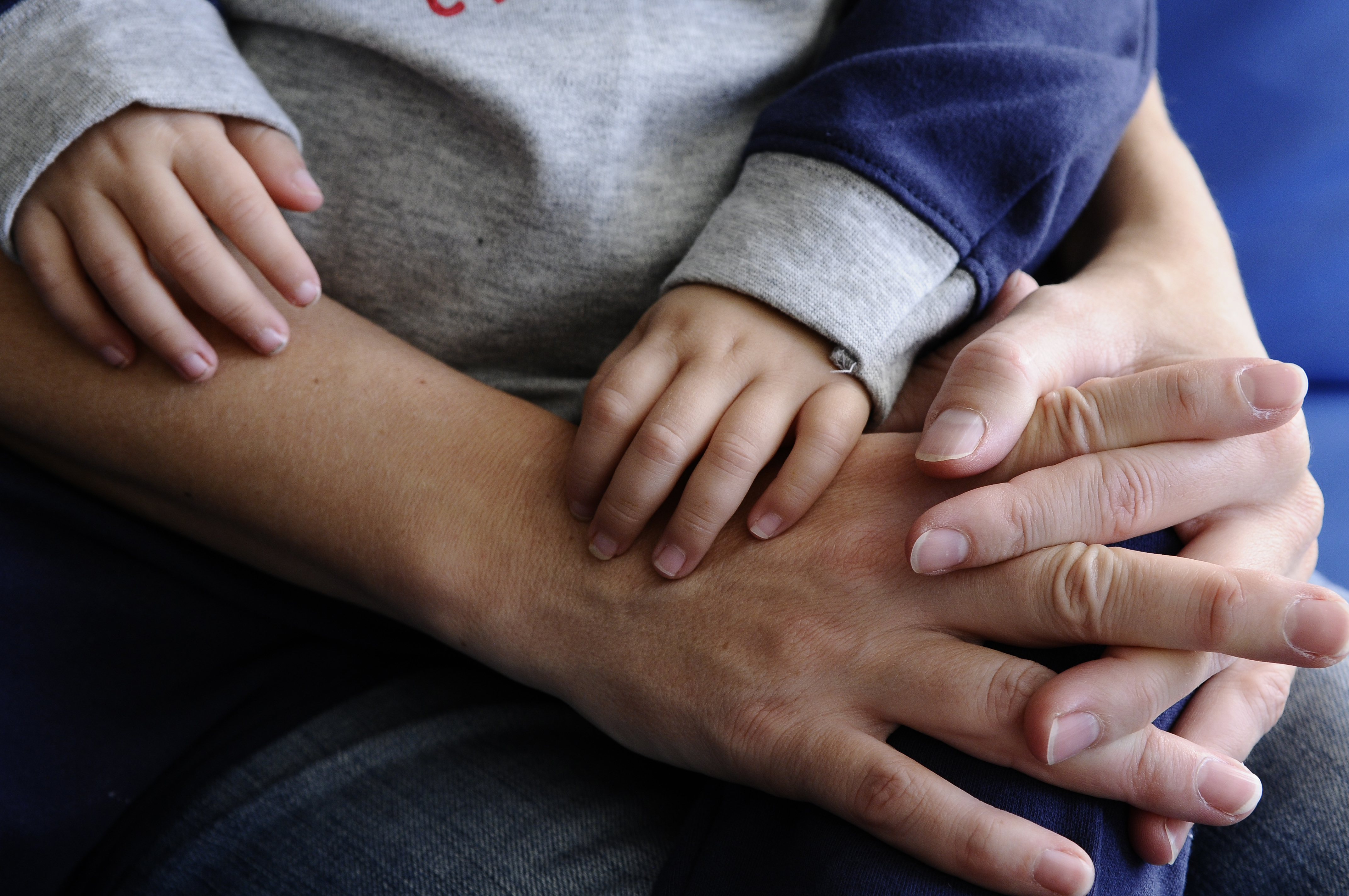 close-up of mother and son hands together