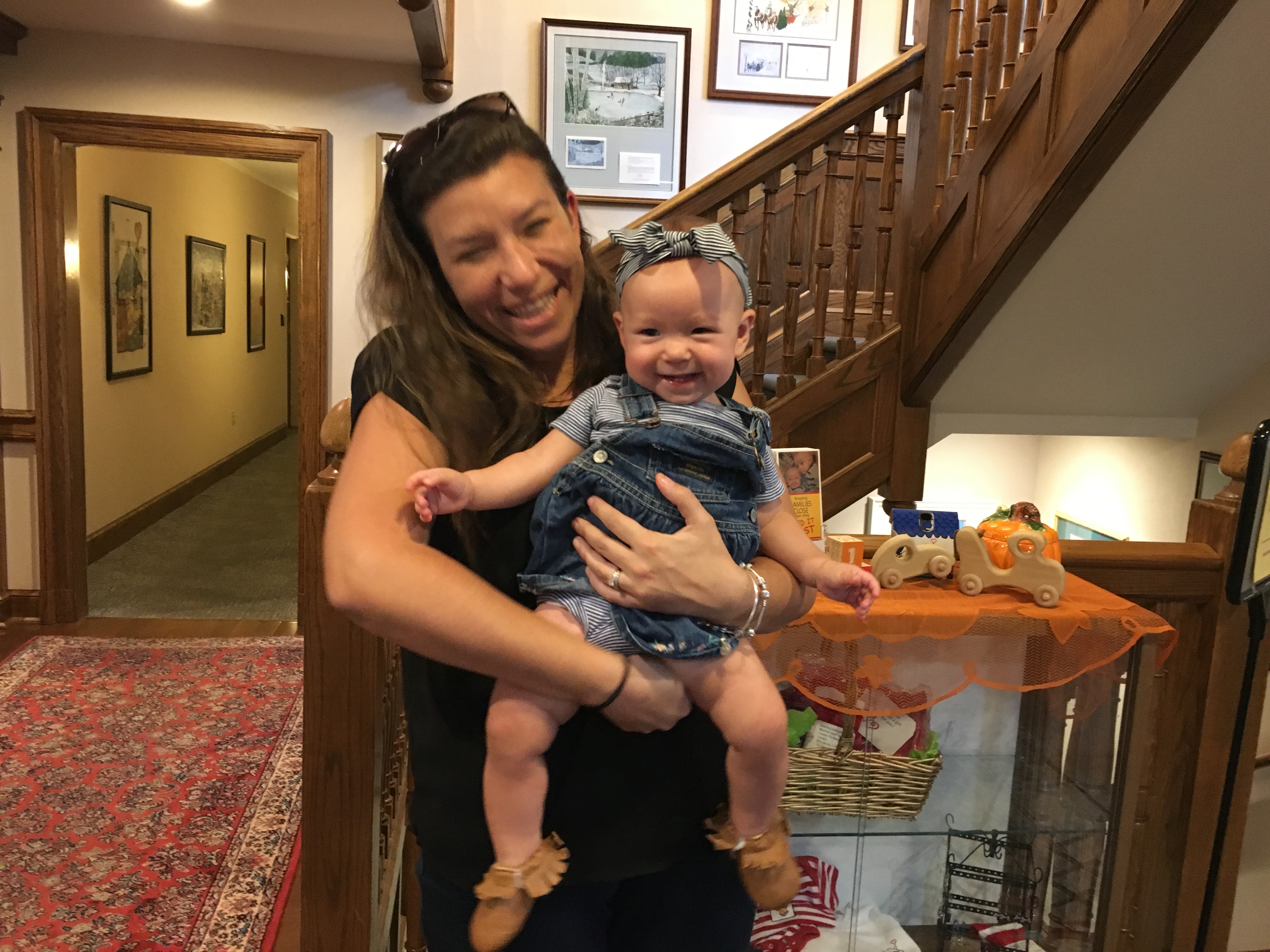 Mother smiles while holding daughter